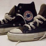 Worn Black High Top Chucks  Worn black felt high tops with brown felt tongue and rear trim and embroidered side patch, side views.