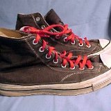 Worn Black High Top Chucks  Vintage black high tops with red laces, side view.