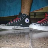 Worn Black High Top Chucks  Wearing black high tops with red laces.