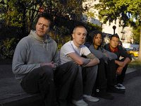Yellowcard  Members of the band sitting on a curb.