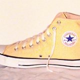 Yellow Chucks  Inside patch  view of a right banana high top chuck.