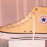 Yellow Chucks  Inside patch  view of a right banana high top chuck.