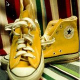 Yellow Chucks  Front and inside patch views of gold high top chucks.